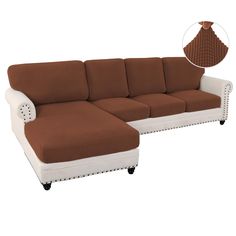 a brown and white sectional couch sitting on top of a wooden table next to a vase