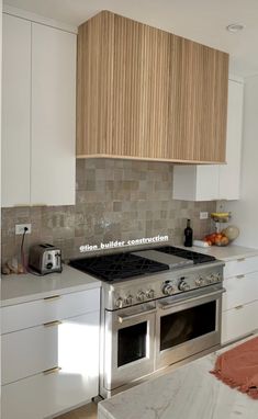 a stove top oven sitting inside of a kitchen