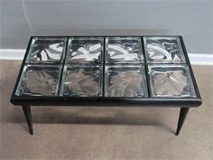 a coffee table with six glass sections on it