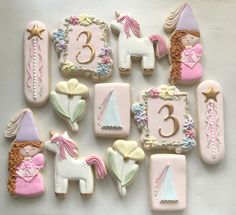 decorated cookies are arranged in the shape of numbers and unicorns, including one with a horse