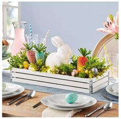 a table set for easter with bunny decorations