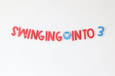 the word swinging into 3 is cut out of red and blue paper