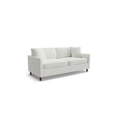 a white couch sitting on top of a white floor