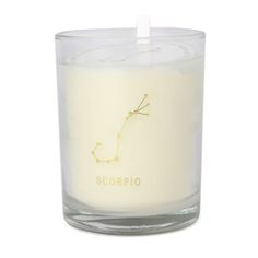 a white candle with the word scorpio on it