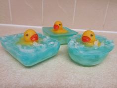 three rubber ducks floating on ice in a bathtub