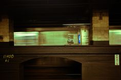 a subway train passing by at night time