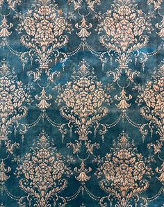 an old blue and gold wallpaper with ornate designs on it's surface,