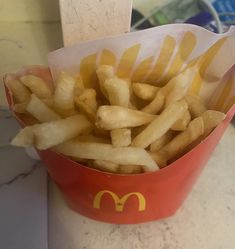 french fries in a red container with mcdonald's logo