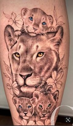 a lion and cubs tattoo on the leg