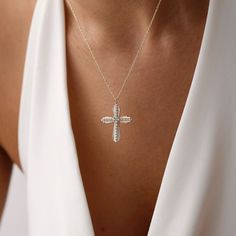 Add dainty to your combinations with our elegant Cross Necklace. Crafted with precision and care, this necklace features a delicate cross pendant adorned with sparkling pave crystals. The elegant design adds a subtle yet stylish accent to any outfit, making it perfect for everyday wear or special occasions. Made from high-quality materials, including durable metal and sparkling crystals, this necklace is designed to last. Its adjustable chain ensures a comfortable fit for everyone, while its tim Crystal Cross Pendant Clavicle Necklace, Elegant Diamond-cut Cross Necklace For Anniversary, Luxury Cross-shaped Gemstone Necklace, Luxury Diamond-accented Cross Pendant Necklace, Diamond-cut Crucifix Cross Necklace, Sterling Silver Cross Necklace, Gold Fashion Necklace, Diamond Cross, Sterling Silver Cross