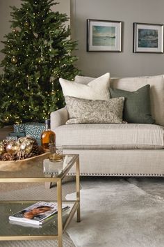 a living room filled with furniture and a christmas tree