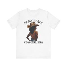 "In My Black Cowgirl Era" T-Shirt: Celebrate your roots and embrace your heritage with our "In My Black Cowgirl Era" t-shirt. This unique design pays homage to the rich history and spirit of Black cowgirls, whose contributions to the equestrian world have often been overlooked. With bold lettering and a vintage-inspired vibe, this shirt is perfect for anyone proud of their Black cowgirl heritage or those who appreciate the untold stories of Black pioneers in the American West. Wear it proudly as a statement of empowerment, resilience, and cultural pride. Whether you're a seasoned rider, a history enthusiast, or simply someone who loves standout fashion with a meaningful message, our "In My Black Cowgirl Era" t-shirt is sure to spark conversation and inspire admiration wherever you go. This Black Rodeo, Cowboy Hat Black, Cowgirl Era, American Cowgirl, Black Cowgirl, Bold Lettering, Cowgirl Shirts, My Black, Meaningful Messages