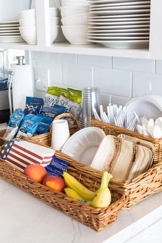 a wicker basket filled with dishes and fruit on top of a kitchen countertop