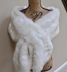 a mannequin wearing a white fur stole