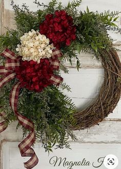 a wreath with red and white flowers on it