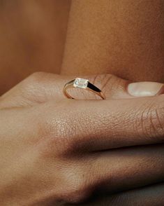 a woman's hand with a ring on it