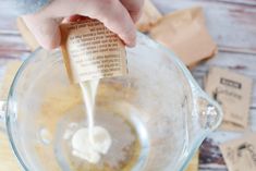 a person pouring something into a blender filled with liquid and ingredients for the recipe