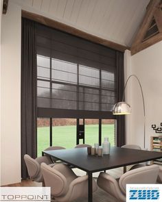 a dining room table with four chairs and a large window in front of it that looks out onto a grassy field