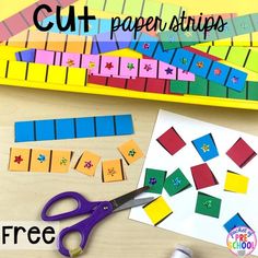 cut paper strips and scissors on a table with crafting supplies to make them look like they are made out of construction paper