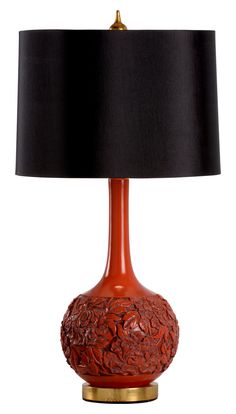 a red table lamp with a black shade