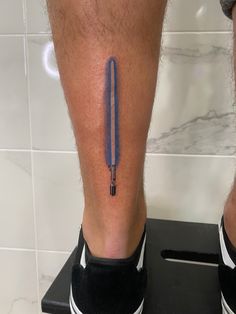 a man's leg with a blue pen on it