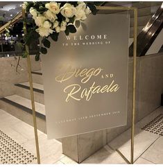 a welcome sign for the wedding of diego and rizabella in front of an escalator