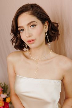 Add a touch of graceful elegance to your bridal look with the Whispering Pearl Drop Earrings! These stunning dangle earrings feature freshwater pearls delicately hanging from a fine gold chain, creating a perfect balance of timeless beauty and modern sophistication. Why do we love them? They’re the perfect blend of chic and classic beauty, making them a must-have for your special day! EARRING FEATURES Material: Brass, Freshwater Pearls Dimensions/Size: 3.2" drop Finish: Polished 14k Gold Plating Elegant Gold Threader Earrings, Elegant Dangle Pearl Necklace For Parties, Elegant Pearl Dangle Necklace For Party, Elegant Pearl Pendant Necklace For Parties, Delicate Pearl Drop Linear Earrings For Party, Long Drop Pearl Charm Necklace For Wedding, Dangle Pearl Earrings With Adjustable Chain, Wedding Long Drop Necklace With Pearl Charm, Elegant Threader Earrings For Party