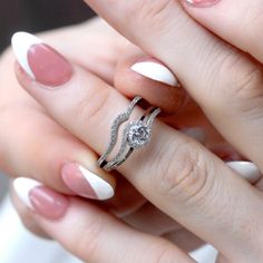 a woman's hand with two rings on it and one ring in the middle