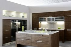 a modern kitchen with wooden cabinets and stainless steel appliances