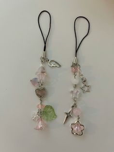 two necklaces with charms attached to them