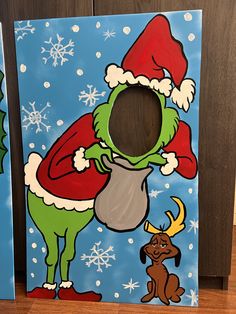 the grinch is holding a cup in his hand while standing next to another painting