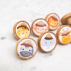 wooden buttons with animals on them sitting on a table