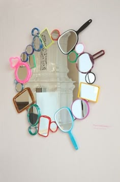 there is a mirror that has many different items in the shape of glasses on it