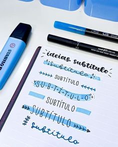 some type of writing on top of a white table with blue markers and pencils