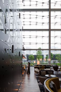 the interior of a modern office building with glass walls and floor to ceiling windows on both sides