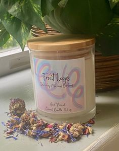 a candle sitting on top of a window sill next to a potted plant