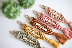 four different colored tassels with the word love spelled on them in small letters