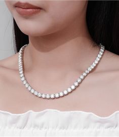 The 6.5mm Moissanite Tennis Chain features 1-carat moissanite stones with D color and VVS clarity, providing unmatched brilliance as a premium diamond alternative. This elegant chain delivers a luxurious look with superior sparkle, perfect for any occasion. A must-have for those who value both style and quality. ✧ Necklace Length: 14" (52Ct)/15"(56Ct)/16”(60Ct)/17"(64Ct)/18"(68Ct)/19"(71Ct)/20"(75Ct)/22"(82Ct)/24"(90Ct) ✧ Stone Dimension: 6.5mm (1CT) ✧ Carat Weight: 1 CT each ✧ Stone Shape: Roun Round Cut Moissanite Tennis Necklace In White Gold, Dazzling Moissanite Tennis Necklace With Diamond Cut, Diamond Cut Moissanite Tennis Necklace For Anniversary, Luxury Round Moissanite Tennis Necklace, Luxury Moissanite Round Tennis Necklace, Formal Round Moissanite Tennis Necklace, Formal Moissanite Tennis Necklace, White Moissanite Tennis Necklace For Anniversary, Diamond White Tennis Necklace With Moissanite Accents