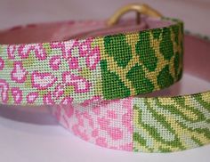 two pink and green dog collars on a white surface