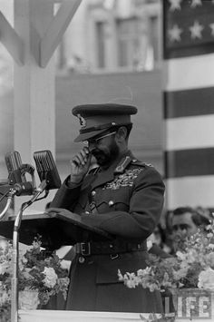 a man in uniform standing at a podium