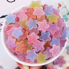 a bowl filled with gummy bears sitting on top of a table