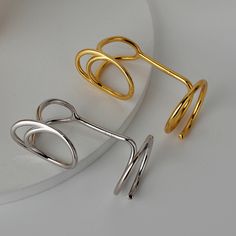 This stylish Silver Geometric Adjustable Line Finger Tip Band Ring adds a modern and chic touch to any outfit. Its geometric design is carefully crafted from sterling silver and can be adjusted to fit any finger size. Perfect for any occasion, it adds a timeless element to any jewelry collection. Product Details Material: 925 Silver Color: 18K Gold/White Gold Plated Size: US Opening size 6.25 (adjustable size 5.5-7.5) Weight: about 2.8-3.0g SKU: AR23101306-G/AR23101306-W Product Keywords: Distor Modern Silver Ear Cuff For Formal Occasions, Modern Open Ring Ear Cuff As Gift, Modern Metal Midi Rings For Formal Occasions, Modern Silver Ear Cuff, Modern Sterling Silver Ear Cuff, Adjustable Sterling Silver Modern Ear Cuff, Modern Adjustable Sterling Silver Ear Cuff, Adjustable Modern Sterling Silver Ear Cuff, Modern Silver Open Ring Ear Cuff