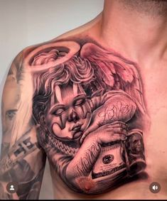 a man with tattoos on his chest holding a camera