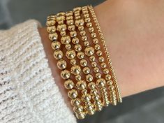 These gold bead bracelets make the perfect everyday accessory. Stack them up in different sizes for an easy, trendy look! They are hand strung on a strong, stretchy cord that's built to last so that you can truly never take them off. P.S. Pair these with the color strip gold bead bracelets for a pop of color! Details: -14k gold filled beads are waterproof and will not tarnish -6.5" long -Choose from 3mm, 4mm, or 5mm beads Bead Stretch Bracelets, Gold Bead Bracelets, Bead Bracelets, Everyday Accessories, Beaded Stretch Bracelet, Gold Beads, Stretch Bracelets, P S, Bracelet Making