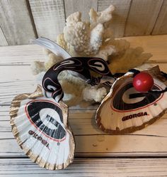 two paper fans sitting on top of a wooden table next to some cotton floss