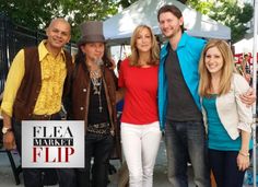 a group of people standing next to each other in front of a sign that says flea market flip