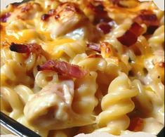 a close up of a plate of macaroni and cheese with bacon on it