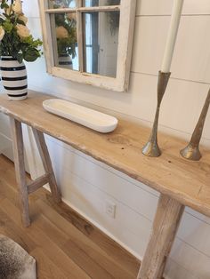 a wooden table with two candles on it