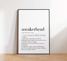 a black and white poster with the words sneakerhead on it in an empty room