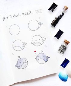 a sheet of paper with drawings of whales and other things on top of it next to some pens